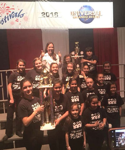 St. Bonaventure School's Children's Chorale hoist their trophies celebrating their first place win in the category of Elementary School Concert Choir at the Music USA Festival held at Universal Studios in Orlando. The choir also received a superior rating.